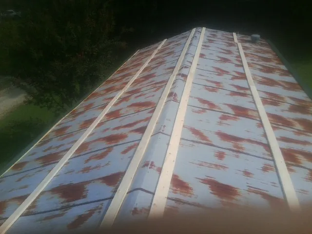 Rusted metal roof panels with new wood purlins before replacement — Storm Damage Roof Repair in Ketchum by Roofing Brothers