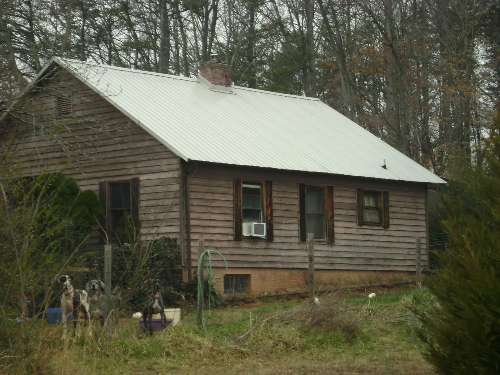 White metal roof on an old wood sided farmhouse, from a Metal Roof Installation job in Ketchum